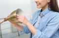 Woman changing light bulb in lamp indoors Royalty Free Stock Photo