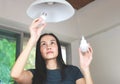 Woman  changing light bulb , from spiral  light bulb to LED light bulb. Slective focus on woman eyes Royalty Free Stock Photo