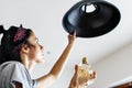 Woman changing lightbulb at home Royalty Free Stock Photo