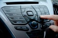 Woman`s hand pressing buttons on a car`s dashboard Royalty Free Stock Photo