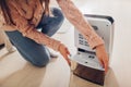 Woman changing water container of dehumidifier at home. Dampness in apartment. Modern air dryer Royalty Free Stock Photo