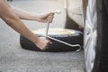 Woman changing wheel on a roadside Royalty Free Stock Photo