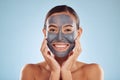 Woman, charcoal and face mask for skincare, beauty and natural cosmetics cleaning product on studio, blue background Royalty Free Stock Photo