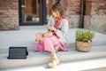 Woman charge phone from a portable solar panel