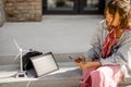 Woman charge phone from a portable solar panel