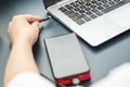 Woman charges her laptop with power bank Royalty Free Stock Photo