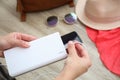 Woman charging mobile phone with power bank while getting ready for travel, closeup Royalty Free Stock Photo