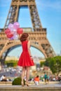 Woman charming girl playing with many colorful balloons. Summer in Paris celebration happiness and lifestyle Royalty Free Stock Photo