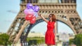 Woman charming girl playing with many colorful balloons. Summer in Paris celebration happiness and lifestyle Royalty Free Stock Photo