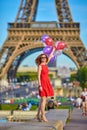 Woman charming girl playing with many colorful balloons. Summer in Paris celebration happiness and lifestyle Royalty Free Stock Photo