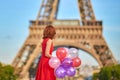 Woman charming girl playing with many colorful balloons. Summer in Paris celebration happiness and lifestyle Royalty Free Stock Photo