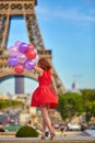 Woman charming girl playing with many colorful balloons. Summer in Paris celebration happiness and lifestyle Royalty Free Stock Photo