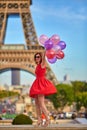 Woman charming girl playing with many colorful balloons. Summer in Paris celebration happiness and lifestyle Royalty Free Stock Photo