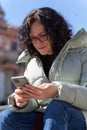 Woman chatting with her smartphone Royalty Free Stock Photo