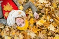 Woman in checked coat lying in autumn park Royalty Free Stock Photo