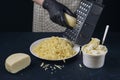 Woman in checkered apron and black gloves rubs cheese on a grater. Home cooking. Adjarian Khachapuri Recipe Ã¢â¬â Georgian cheese Royalty Free Stock Photo