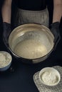 Woman in checkered apron hold bowl with liquid yeast dough. Process of making bakery. Adjarian Khachapuri Recipe Ã¢â¬â Georgian Royalty Free Stock Photo