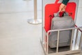 Woman checking backpack metal cage checking carry-on luggage at airport. Royalty Free Stock Photo