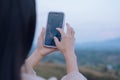 Woman is checking Bitcoin price chart on digital exchange on smartphone, cryptocurrency future price action prediction