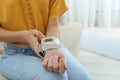 Woman checking blood pressure at home, closeup with space for text. Royalty Free Stock Photo