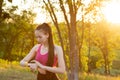 Woman checking fitness and health tracking wearable device in the park.