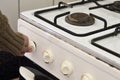 Woman checking gas, trying to turn on gas on old gas stove Royalty Free Stock Photo