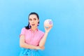 Woman Checking her Financial Status Shaking Piggy Bank