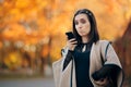 Surprised Autumn Girl Holding Smartphone Reading a text Royalty Free Stock Photo