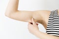 Woman checking her upper arm. Arm fat Royalty Free Stock Photo