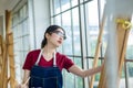 Woman is checking and inspecting products. Woman hold clip board write plan list in ware house. Young woman business woman standin Royalty Free Stock Photo