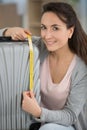 woman checking luggage measurments before vacation Royalty Free Stock Photo