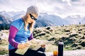 Woman checking map hiking in mountains