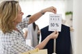 Woman checking out discounted clothes Royalty Free Stock Photo