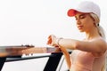 Woman checking progress on smart watch, Woman runner looking at heart rate monitor smart watch, training outdoors on bridge Royalty Free Stock Photo