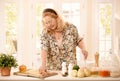Woman checking recipe in kitchen Royalty Free Stock Photo