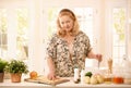 Woman checking recipe in kitchen Royalty Free Stock Photo