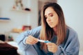 Woman Checking the Results of a Pregnancy Test at Home Royalty Free Stock Photo