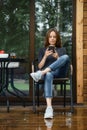 Woman checking what is online sitting on terrace