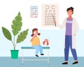 Woman checks the child s eyesight. Table for testing visual acuity in the ophthalmologist s office