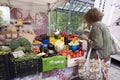 Woman checks vegetables on open air market of briancon in the french haute provence