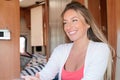 Woman cheerful portrait smiling in camper van vacation in motor rv home interior lifestyle in vanlife