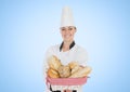 Woman chef with bread against blue background Royalty Free Stock Photo