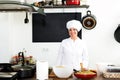 Woman chef cooking food at cafe`s kitchen Royalty Free Stock Photo