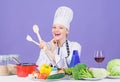 Woman chef cooking healthy food. Gourmet main dish recipes. Cooking is her hobby. Girl in hat and apron. Delicious Royalty Free Stock Photo