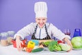 Woman chef cooking healthy food. Gourmet main dish recipes. Delicious recipe concept. Girl in hat and apron. Cooking Royalty Free Stock Photo