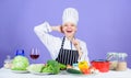 Woman chef cooking healthy food. Gourmet main dish recipes. Girl in hat and apron. Delicious recipe concept. Cooking Royalty Free Stock Photo