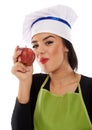 Woman chef eating red apple Royalty Free Stock Photo
