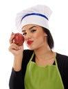 Woman chef eating red apple Royalty Free Stock Photo