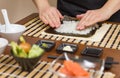 Woman chef filling japanese sushi rolls with rice Royalty Free Stock Photo