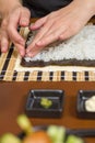 Woman chef filling japanese sushi rolls with rice Royalty Free Stock Photo